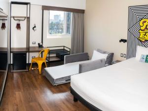 a hotel room with two beds and a desk at ibis styles Lima San Isidro in Lima +147 photos