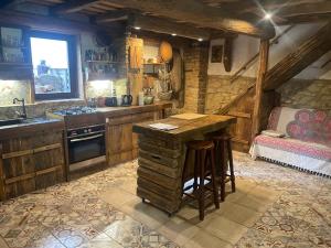 a kitchen with a table and a sink and a bed at Anna Porta in Kan +33 photos