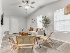 a living room with a couch and a ceiling fan at Oak & Elm 2BR King & Queen Edmond, OK in Edmond