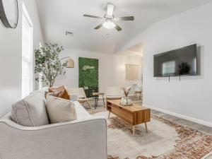 a living room with a couch and a tv at Oak & Elm 2BR King & Queen Edmond, OK in Edmond