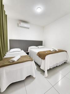 a bedroom with two beds with towels on them at Dona Olivia Universidade 16 in Vitória da Conquista +29 photos
