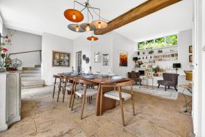 a dining room with a wooden table and chairs at Fanny à la Campagne in Nantoux