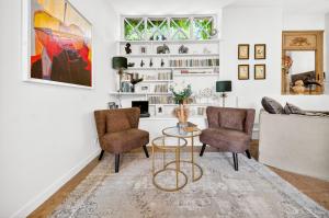 a living room with two chairs and a table at Fanny à la Campagne in Nantoux +27 photos