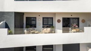 a balcony of a building with chairs and tables at Paradise Resort 315 in San Miguel de Salinas