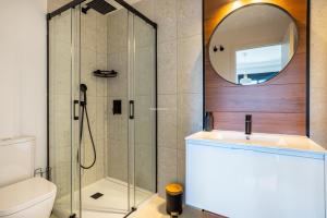 a bathroom with a shower and a sink and a mirror at Paradise Resort 315 in San Miguel de Salinas