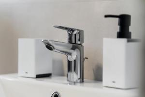 a bathroom sink with a faucet and two toilets at Adriatica sea view apartment in Baošići +24 photos
