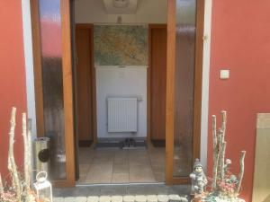 an open door to a room with a radiator at Kašperky Apartmány in Kašperské Hory