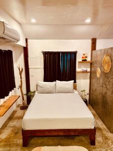 a bedroom with a bed and a black curtain at Happiness Beach Resort Siargao in General Luna +51 photos
