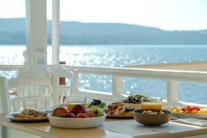 a table with plates of food on a cruise ship at Trinity Suites Ammouliani Hospitality in Ammouliani