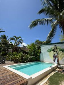 a swimming pool with a painting on the side of a house at Happiness Beach Resort Siargao in General Luna