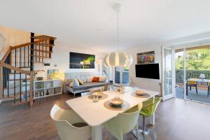 a living room with a table and chairs and a couch at Casa 3 Rose Lake View and Pool in Toscolano Maderno