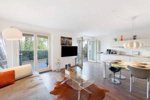 a living room with a couch and a table at Casa 3 Rose Lake View and Pool in Toscolano Maderno