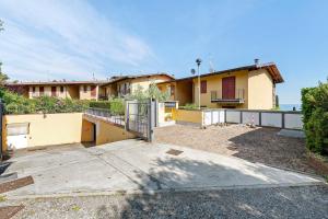 a house with a gate in front of it at Casa 3 Rose Lake View and Pool in Toscolano Maderno