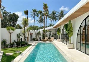 a swimming pool in the backyard of a house at Melrose x The Young Villas in Uluwatu