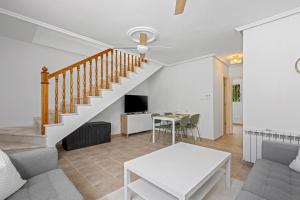a living room with a staircase and a table at Casa Nemo in Rojales