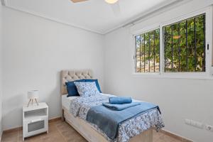 a white bedroom with a bed and a window at Casa Nemo in Rojales +18 photos