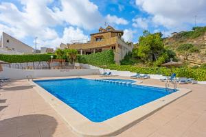 a large swimming pool in front of a house at Casa Nemo in Rojales
