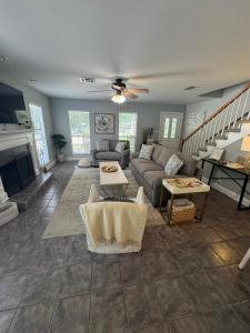 a living room with a couch and a fireplace at Sleepy Lagoon Cottage in Covington