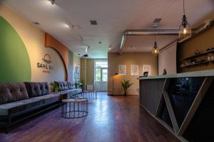 a living room with a couch and a table at Sahil Bay Hostel in Baku