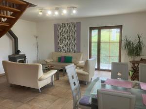 a living room with chairs and a couch and a table at Kašperky Apartmány in Kašperské Hory