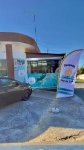 a bus parked in front of a building with a sign at Pousada Luz do Sol in Penha