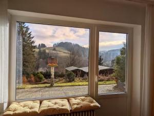 a large window with a couch in a living room at Haus Kiel in Altenau