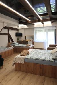 a bedroom with four beds in a room at Zajazd Stodoła sauna w cenie in Stronie Śląskie