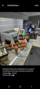 a kitchen counter with eggs and vegetables on a cutting board at Dunfolan House in Dundrum
