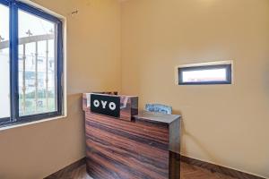 a room with a wooden counter with a sign on it at Hotel O New Friends Hotel in Prayagraj