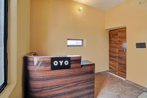 a room with a wooden door with a sign on it at Hotel O New Friends Hotel in Prayagraj
