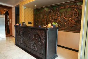a room with a large painting on the wall at Hotel Sangiliyan in Jaffna