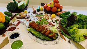 a table with a bunch of food on it at Hotel Bhaskar-Near Jaipur Airport in Jaipur