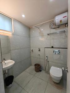 a bathroom with a toilet and a sink at The Aspire Hotel Guwahati in Guwahati +45 photos