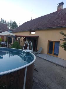 a swimming pool in front of a house at Pohádka in Kunratice