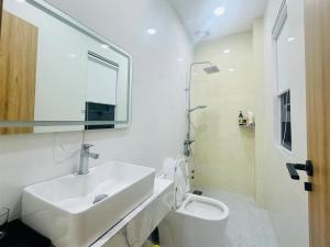 a white bathroom with a sink and a toilet at Lighthouse Hotel & Apartment Phan rang in Kinh Dinh +29 photos