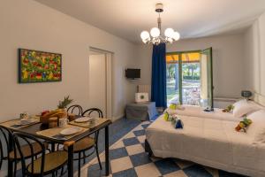 a living room with a bed and a table with chairs at Club del Sole Le Gorette Cecina Easy Camping Village in Marina di Cecina +62 photos
