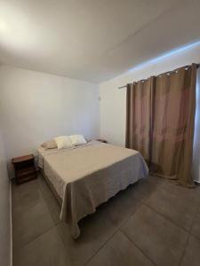 a bedroom with a large bed and a curtain at Duplex en Luque in Zarate Isla