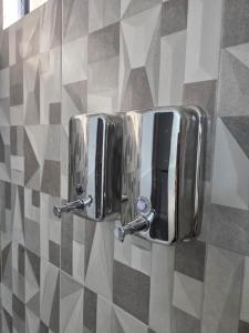 a pair of metal paper towel dispensers on a wall at Duplex en Luque in Zarate Isla +11 photos