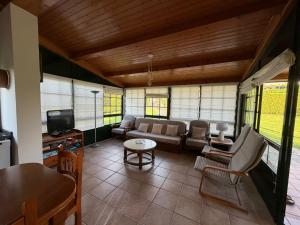 a living room with a couch and a tv at Chalet privado playa de Boa in Noya