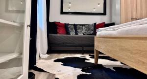 a bedroom with a bed with pillows and a rug at Apartmány Benešov in Benešov nad Ploučnicí