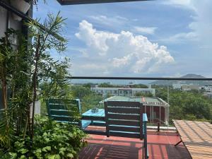 a balcony with two chairs and a view of a city at Lighthouse Hotel & Apartment Phan rang in Kinh Dinh