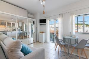 a living room with a couch and a table at Casa Lori Albufeira in Albufeira