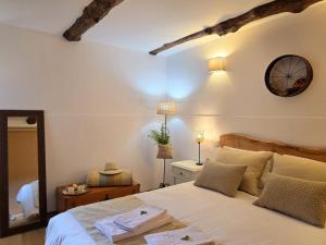 a bedroom with a bed and a clock on the wall at Casa Rio D'Além in Melgaço