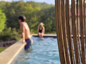 a couple of people in a swimming pool at Casa Rio D'Além in Melgaço +19 photos