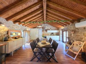 a kitchen and dining room with a table and chairs at Casa Rio D'Além in Melgaço