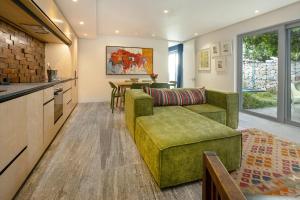 a living room with a couch and a table at 17 Marine - Apt 103 - Private Hot Tub & Garden in Hermanus
