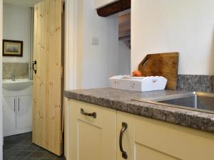 a kitchen with a sink and a counter with a box on it at Toad Hall in Helmsley