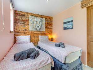 a bedroom with two beds with towels on them at By The Beach- Uk31201 in Downderry