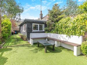 a backyard with a bench and a house at By The Beach- Uk31201 in Downderry +28 photos