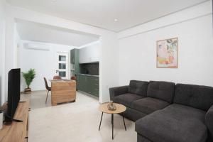 a living room with a couch and a table at Local View Apartments in Polychrono